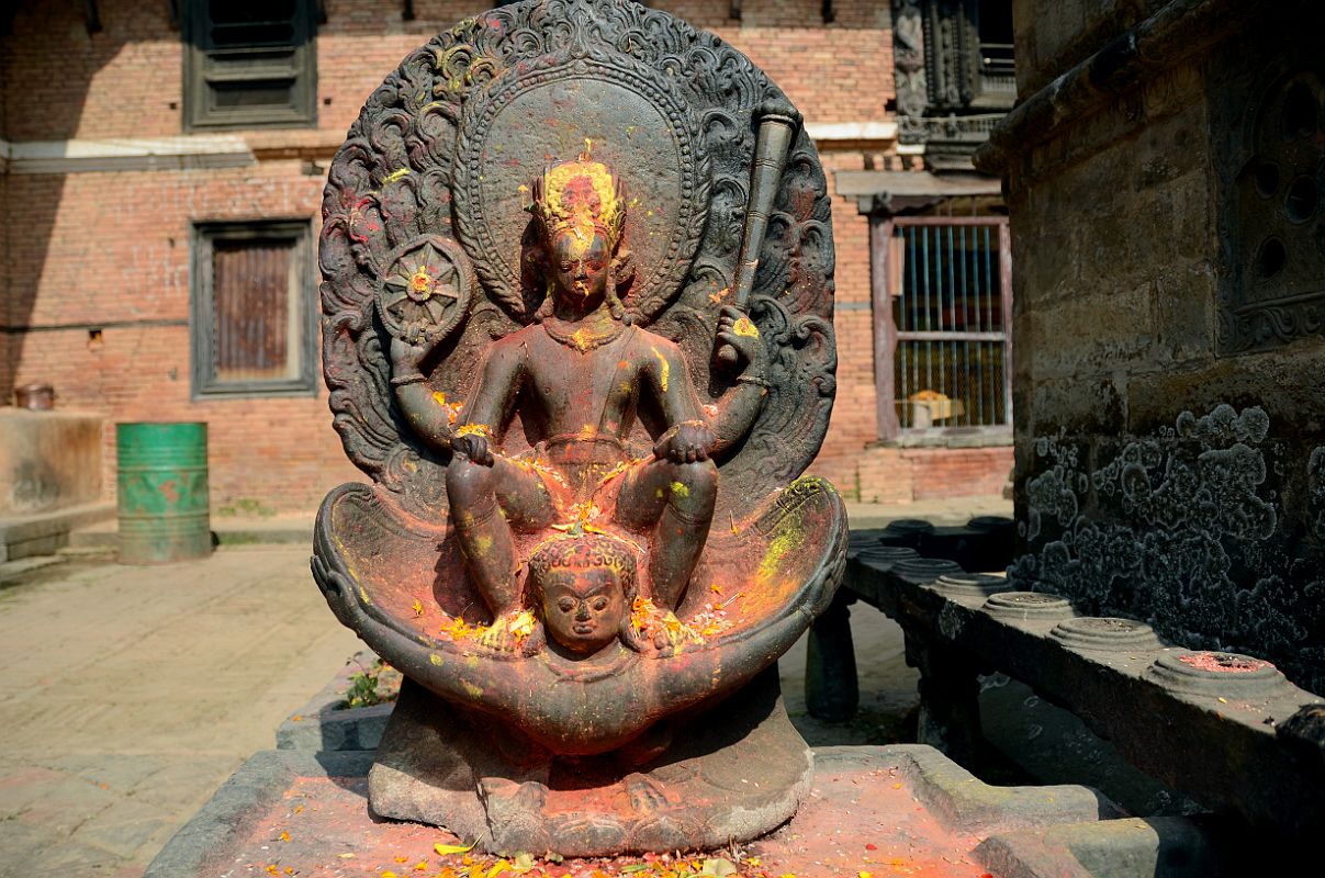 Kathmandu Changu Narayan 24 7C Image Of Vishnu Riding Garuda Just To The North Of Main Entrance To Changu Narayan Temple In the northwest corner of the Changu Narayan Temple in the Kathmandu Valley is a 7C statue of Vishnu riding on the back of Garuda. Vishnu holds a chakra wheel and a long mace club in his raised hands and a conch shell in his lower hand.